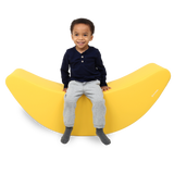 Child sitting on the SensaSoft™ Banana Rocker