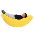 Child laying back on the SensaSoft™ Banana Rocker