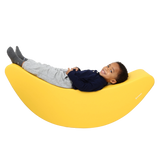 Child laying back on the SensaSoft™ Banana Rocker