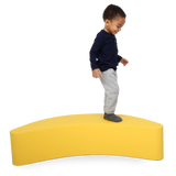 Child standing on the SensaSoft™ Banana Rocker