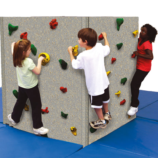 three kids happily using the Tyke Tower Climbing Wall