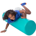 Girl smiling while playing on the SensaSoft™ Rockin Roll Top