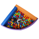 Top view of child laying in the SensaSoft™ Foldable Ball Pit - Corner