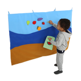 Child putting items on the Felt Storyboard