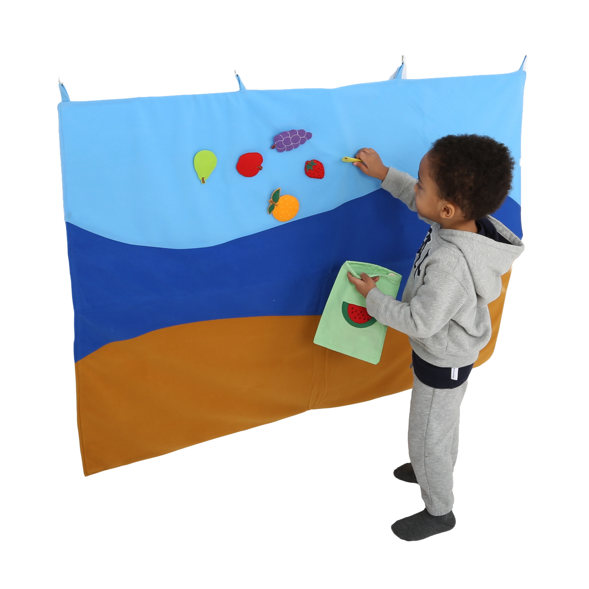 Child putting items on the Felt Storyboard