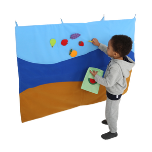Child putting items on the Felt Storyboard