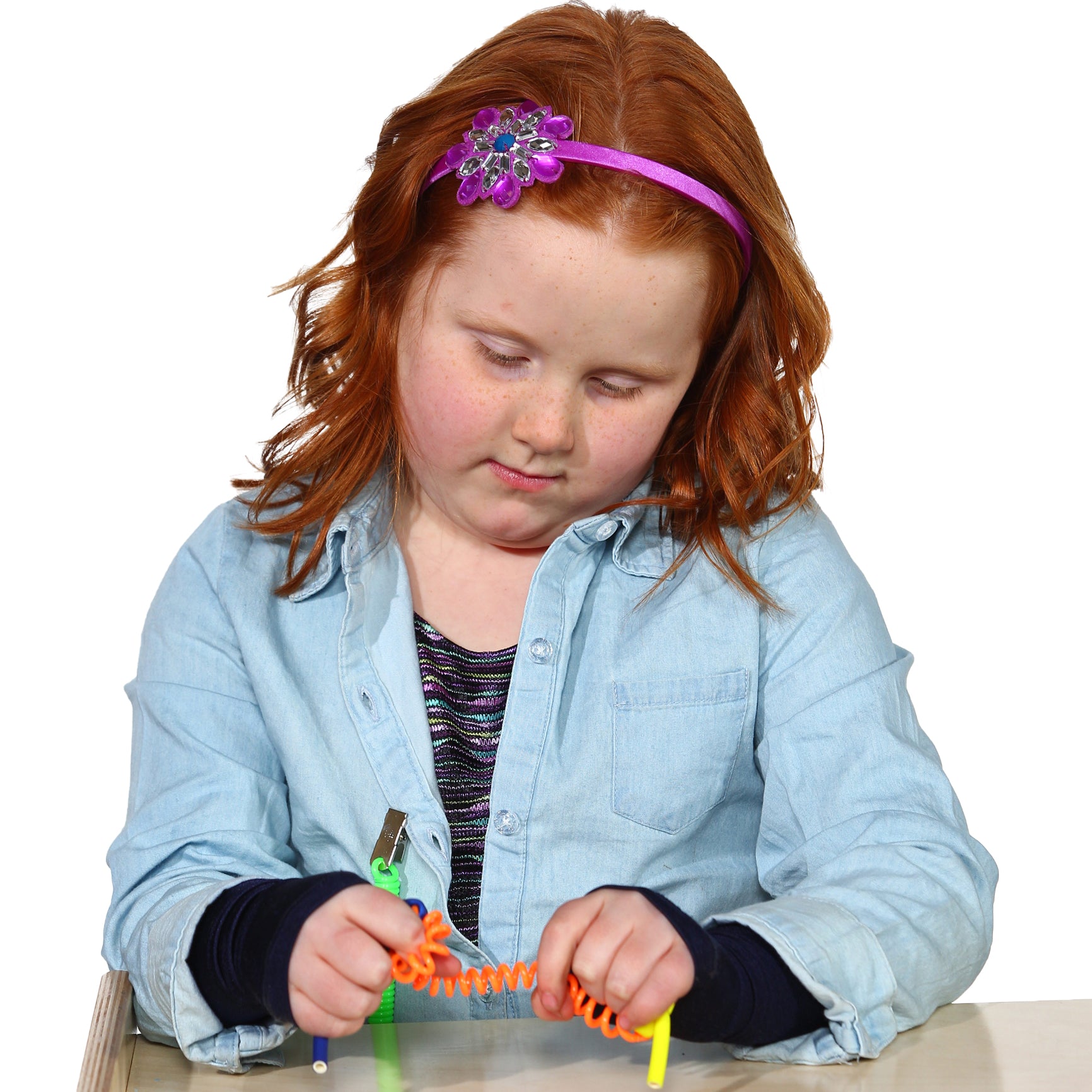 Girl playing while wearing the Sensory Sleeves