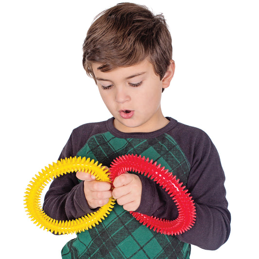 Boy playing with the yellow and red Sensory Twists