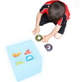 Child playing with sensory alphabet in the LimeLite™ LED Sand Table