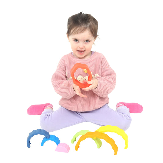 Child playing with the Ripple Rainbow Stacker