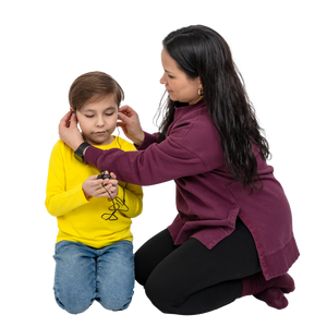 Woman adjusting headphones on a child against a white background