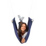 girl laying on her front with feet up inside the blue Soft Taco Swing