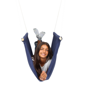 girl laying on her front with feet up inside the blue Soft Taco Swing