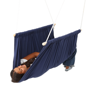 girl lying on her back in the blue Soft Taco Swing