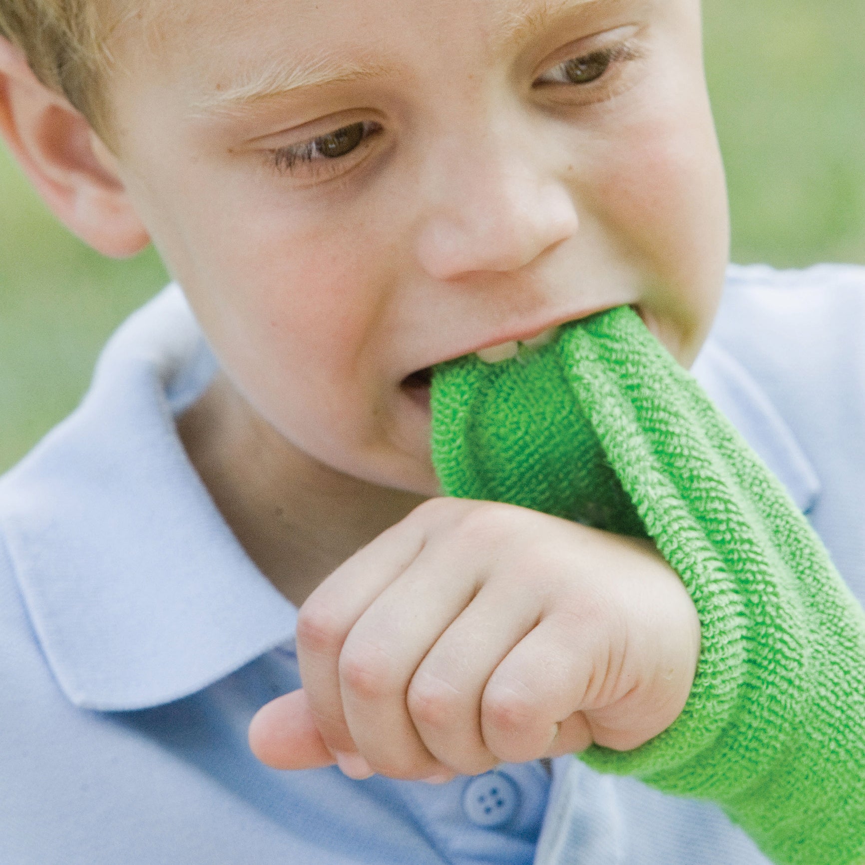 Boy using the green Chewy Wristband