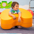 Kid smiling while playing with sensory toys