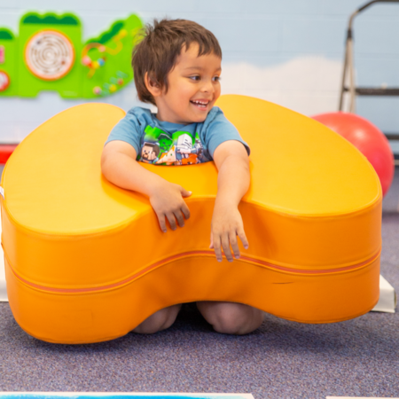 Kid smiling while playing with sensory toys