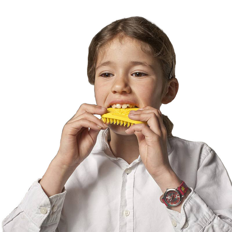 Child using the yellow Tactile Tiger Brush