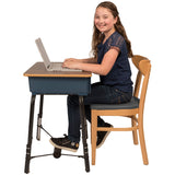 Girl using The Original FootFidget Footrest while typing on a laptop at the desk