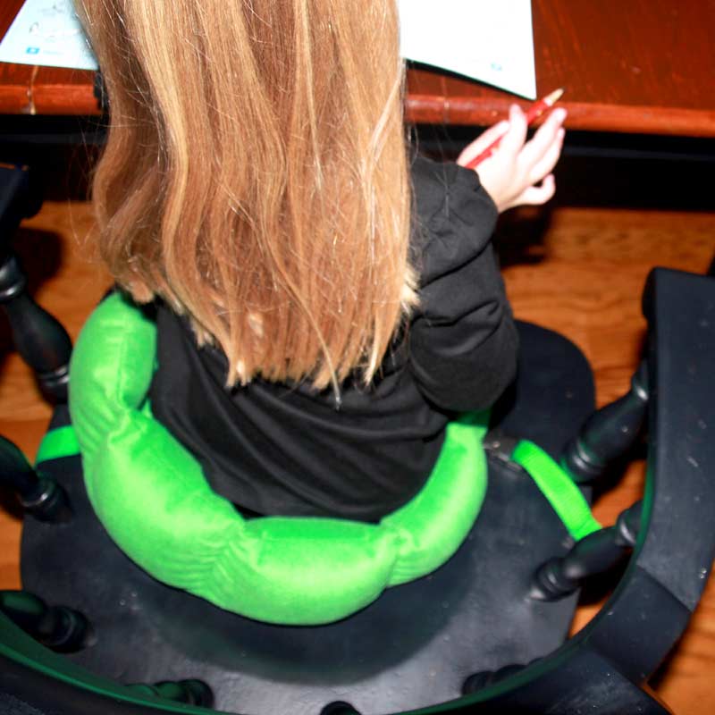 Girl using the green Boundary Chair