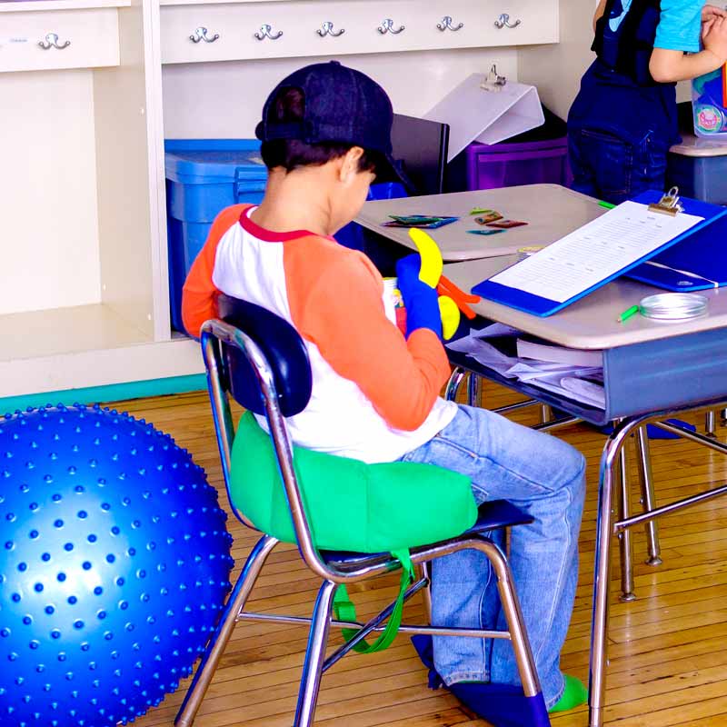 Boy using the green Boundary Chair