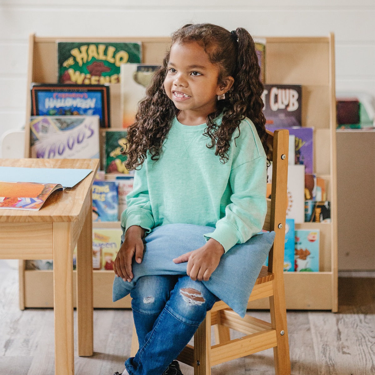 Girl using the Denim Weighted Lap Pad