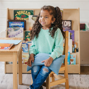 Girl using the Denim Weighted Lap Pad