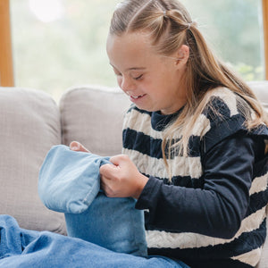 Girl using the Denim Weighted Lap Pad