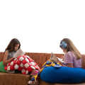 Girls reading while using the Weighted Disc Blankets
