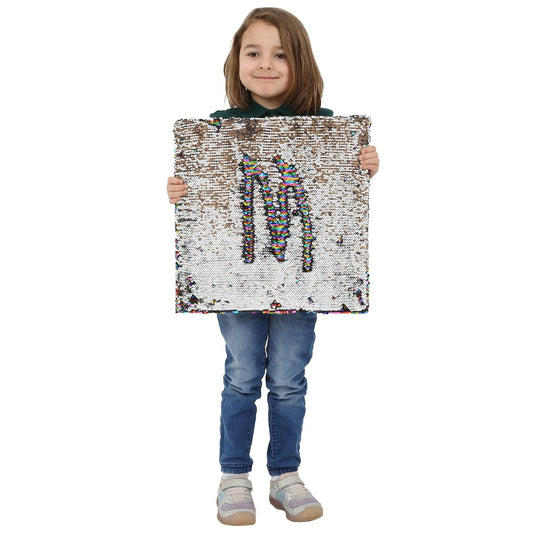 Child smiling while holding the Sensory Wall Panel