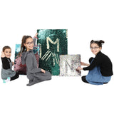 Three kids smiling next to the Sensory Wall Panels