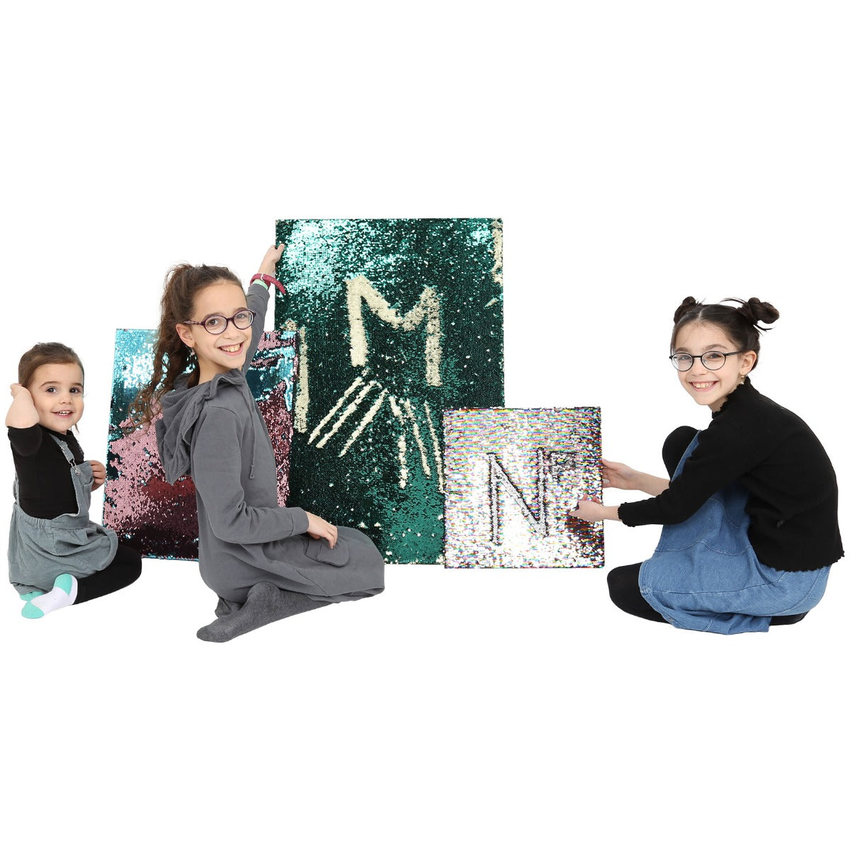Three kids smiling next to the Sensory Wall Panels
