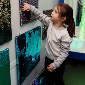 Child playing with a Sensory Wall Panel