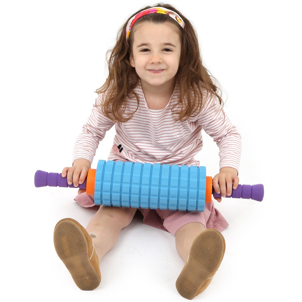 girl smiling while using the 2 in 1 Textured Foam Roller