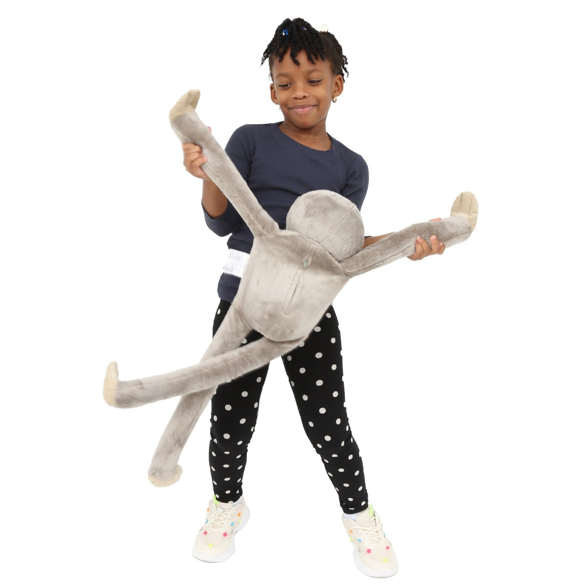 Child smiling while playing with the Sloth Heavy Hugger