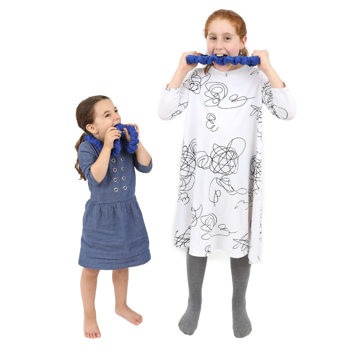 Two girls biting on the Tough Terry Bands