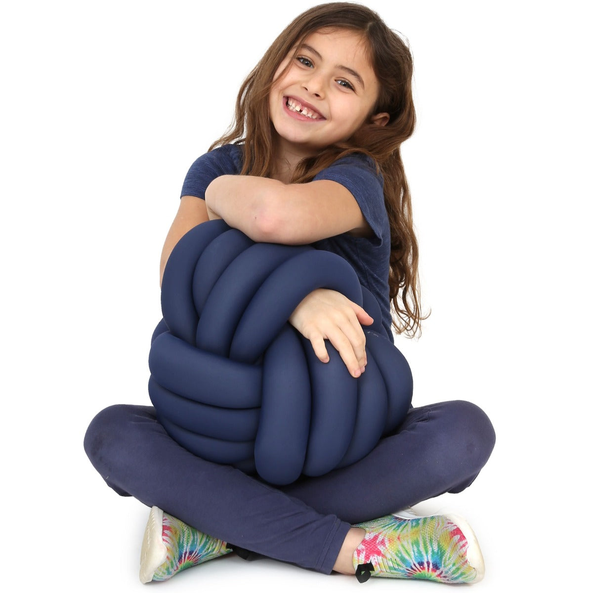 Girl smiling while holding the Weighted Sensory Knot Ball