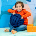 Child using the Weighted Sensory Knot Ball