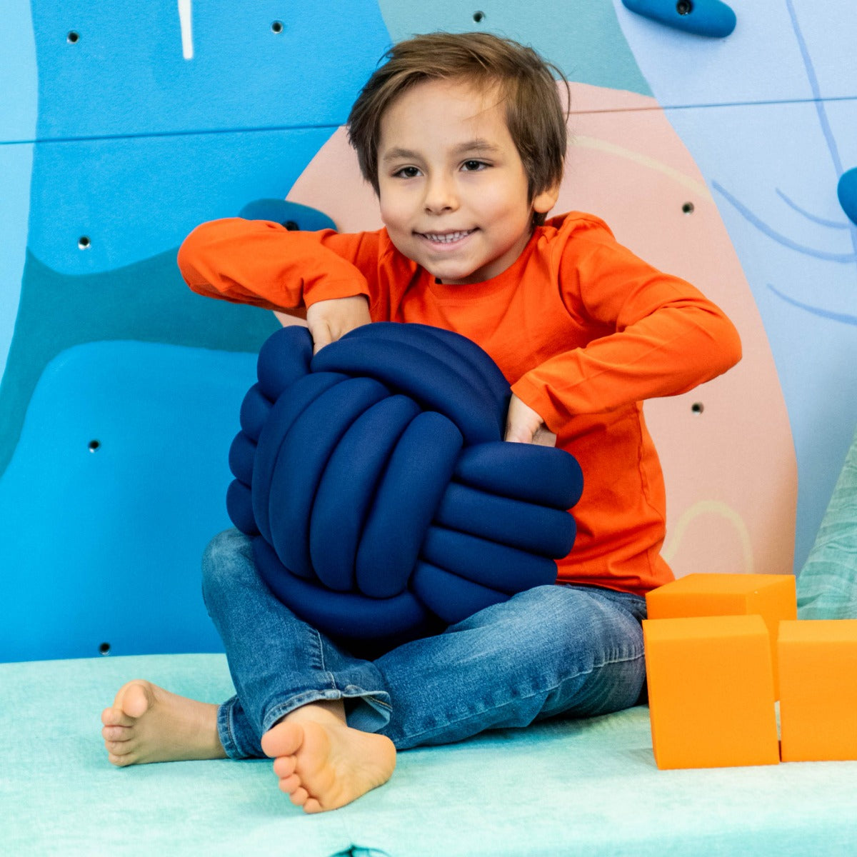 Child using the Weighted Sensory Knot Ball