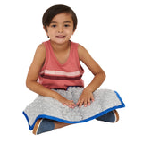 Boy smiling while using the Minky Weighted Lap Pad