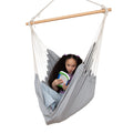Girl reading while using the Hanging Hammock Chair