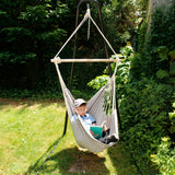 Boy reading while using the Hanging Hammock Chair in the garden