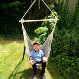 Boy smiling while using the Hanging Hammock Chair in the garden