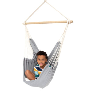 Boy sitting happily in the Hanging Hammock Chair