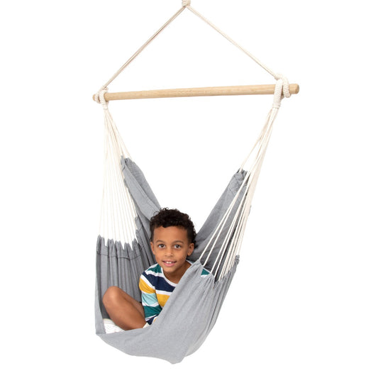 Boy sitting happily in the Hanging Hammock Chair