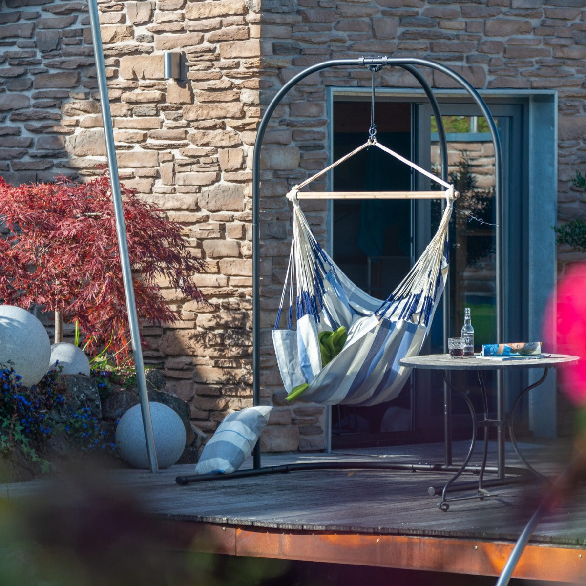 hammock chair hanging on swing stand outdoors 