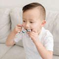 Child biting a Sensory Basics S-Chidget