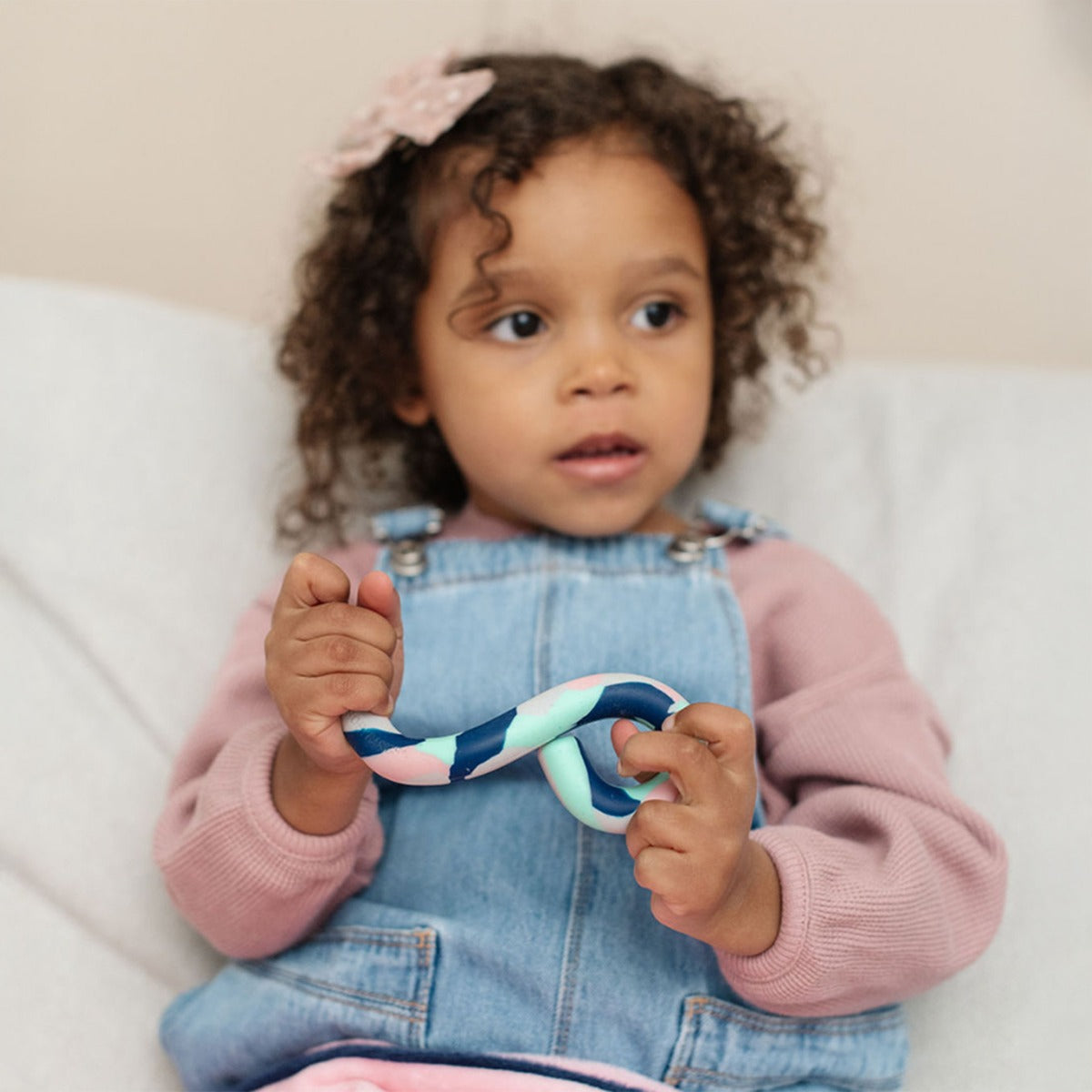 Child holding a Sensory Basics S-Chidget