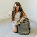 Girl putting the rollease fidget into her backpack