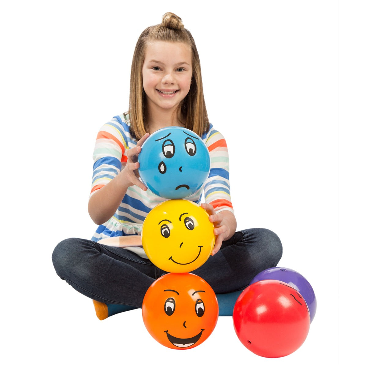 Girl holding the yellow, blue and orange Emotion Balls